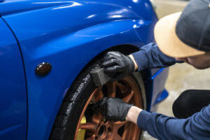 applying a black car tire polish on the wheels applying black car tire polish on the wheels